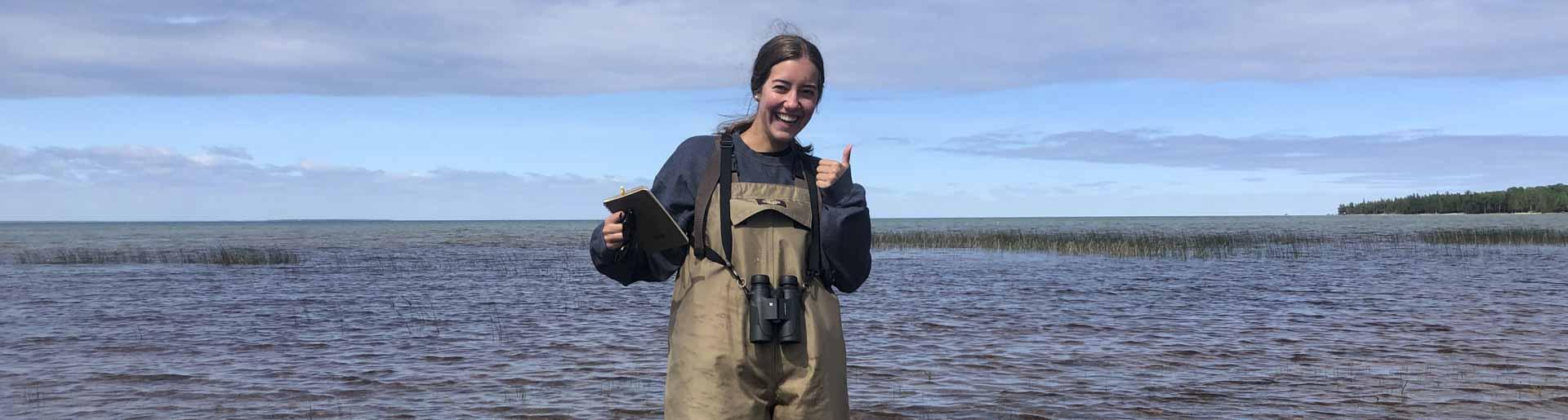 Abby Gosselink conducting research in a river.