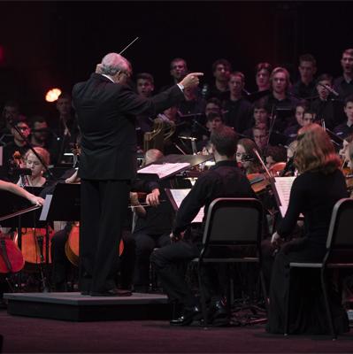Conducor leads orchestra and choir